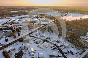 In this aerial view of the landscape, you can see a small town with a home complex covered in snow, the wonderful winter