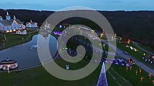 Aerial View of a Large Christmas Light Display, with Farm Buildings and a Pond With Gazebo
