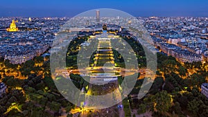 Aerial view of a large city skyline after sunset day to night timelapse. Top view from the Eiffel tower. Paris, France.