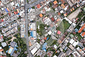 Aerial view of a large city There are many houses arranged in proportions which have a road cut through and a little green area