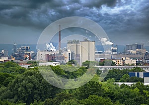 Aerial view of large factory with chimneys emitting smoke into the environment