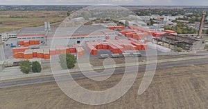 Aerial view of a large factory. Industrial exterior of a modern factory with orange decoration