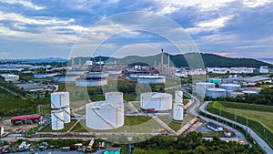 Aerial view of large fuel storage tanks at oil refinery industrial zone, White oil storage tanks farm.