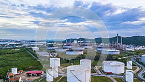 Aerial view of large fuel storage tanks at oil refinery industrial zone, White oil storage tanks farm.