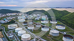 Aerial view of large fuel storage tanks at oil refinery industrial zone, White oil storage tanks farm.