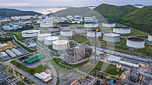 Aerial view of large fuel storage tanks at oil refinery industrial zone, White oil storage tanks farm.