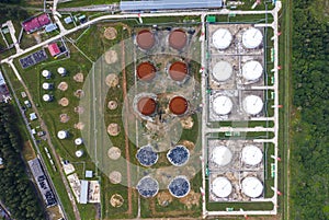 Aerial view of large fuel storage tanks at oil refinery industrial zone, White oil storage tanks farm