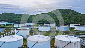 Aerial view of large fuel storage tanks at oil refinery industrial zone, White oil storage tanks farm.