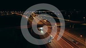 Aerial view of a large multi-lane highway with bridges and viaducts at night