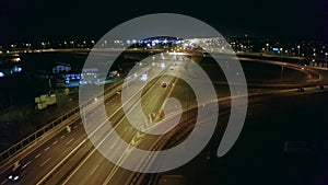 Aerial view of a large multi-lane highway with bridges and viaducts at night