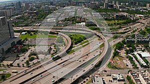 Aerial view of large multilane highway intersection in town. Cars smoothly driving in lanes through multilevel transport