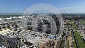 An aerial view of a large oil refining station against green landscape