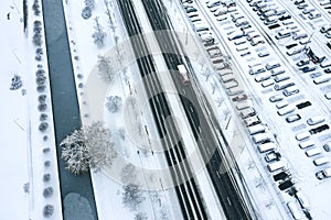 Aerial view of large parking lot with many snow-covered cars in winter. drone photo