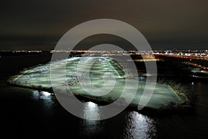 Aerial View of a Large Parking Lot Near A Busy Shipping Port