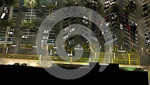 Aerial view of large parking lot at nighttime with many parked cars. Dark carpark at supercenter shopping mall with