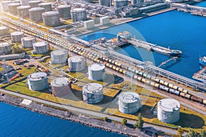 Aerial view large port oil loading terminal with large storage tanks. Railway infrastructure for the delivery of bulk cargo by sea