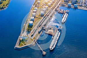 Aerial view large port oil loading terminal with large storage tanks. Railway infrastructure for the delivery of bulk cargo by sea photo