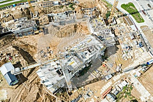 Aerial view of large residential area during early stages of construction, with crane and building materials