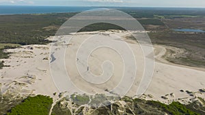 Aerial view of large sand dunes in the middle of Denmark`s forest.