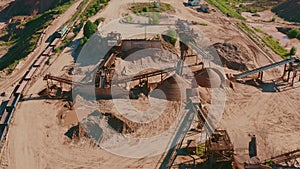 Aerial view of large sand quarry, sand extraction for construction industry. Drone flies over quarry for mineral