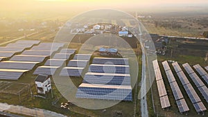 Aerial view of large sustainable electrical power plant with rows of solar photovoltaic panels for producing clean