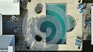 Aerial view of large swimming pool with clear water on home back yard