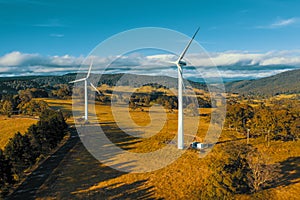 Aerial view of a large three blade industrial wind turbine generating electricity