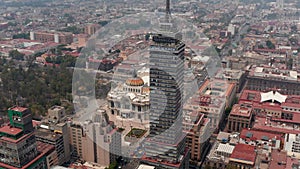 Aerial view of large town cityscape with Torre Latinoamericana tall building and Palacio de Bellas Artes. Drone camera