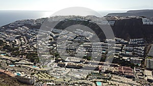 Aerial view of a large urbanization of summer houses in the town of Puerto Rico de Gran Canaria. Spain