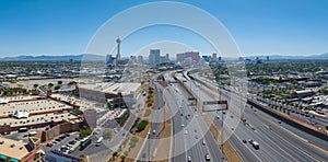 Aerial View of Las Vegas Cityscape with Stratosphere Tower and Casinos Amidst Mountains at Midday