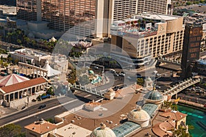 Aerial view of Las Vegas Strip during daylight with grand architecture and bustling urban scene.