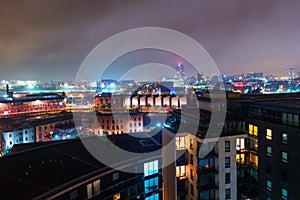 Aerial view of Leeds docks, England, UK during the night. Heavy clouds over the modern buildings