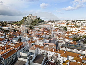 Aerial view of Leiria with red roofs and castle on the hill, Portugal