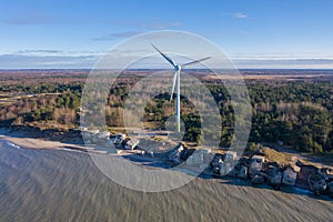 Aerial view of Liepaja Northern Forts, old abandoned fortifications at Baltic sea coast in Latvia. Large wind turbine