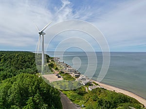 Aerial view of Liepaja Northern Forts, old abandoned fortifications at Baltic sea coast in Latvia. Large wind turbine