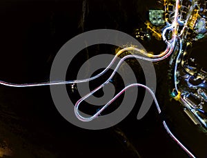 Aerial view of light trails on a winding road at night