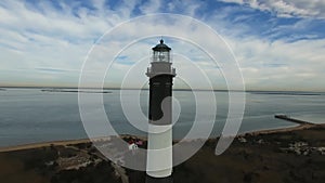 Aerial View of a Lighthouse and Shoreline Close Up on a Sunny Winter Day