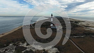 Aerial View of a Lighthouse and Shoreline Close Up on a Sunny Winter Day as Seen by a Drone