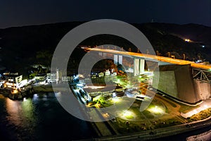 Aerial view of lights from highway rest station by bridge offramp at night