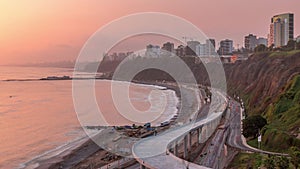 Aerial view of Lima's Coastline in the neighborhood of Miraflores during sunset timelapse, Lima, Peru photo