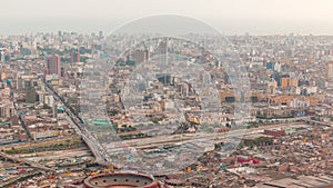 Aerial view of Lima skyline timelapse with Plaza de Toros de Acho bullring from San Cristobal hill. photo