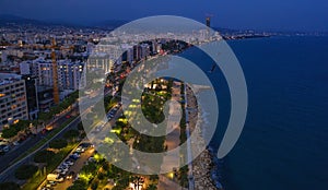 Aerial view of Limassol promenade or embankment with alley and buildings in Cyprus at night. Drone photo of