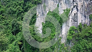 Aerial view of limestone rocks covered with lush tropical greenery. Top view of mountains in Krabi and Suratthani