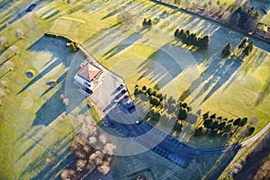 Aerial view of links golf course during summer showing green and bunkers at driving range club house