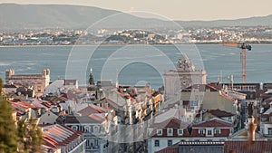 Aerial view of Lisboa downtown timelapse during sunset. Panoramic of Baixa, Rossio and Chiado red rooftops from above