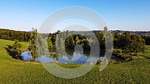 Aerial view of a little lake and trees surrounding, in italian Appennini hills photo