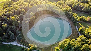 Aerial view of a little lake and trees surrounding, in italian Appennini hills photo