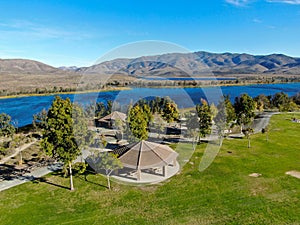 Aerial view of little park in front of Otay Lake Reservoir with blue sky and mountain