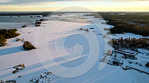 Aerial view of little Swedish village with islands and forests on a Baltic sea coast at winter time. Drone photography - winter in photo