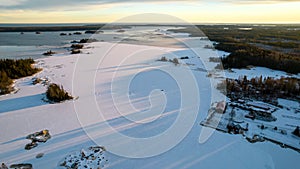 Aerial view of little Swedish village with islands and forests on a Baltic sea coast at winter time. Drone photography - winter in